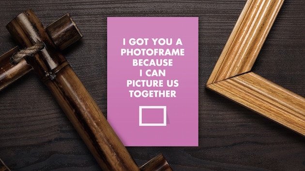 empty frames and old photo on the wooden table; Shutterstock ID 128619539