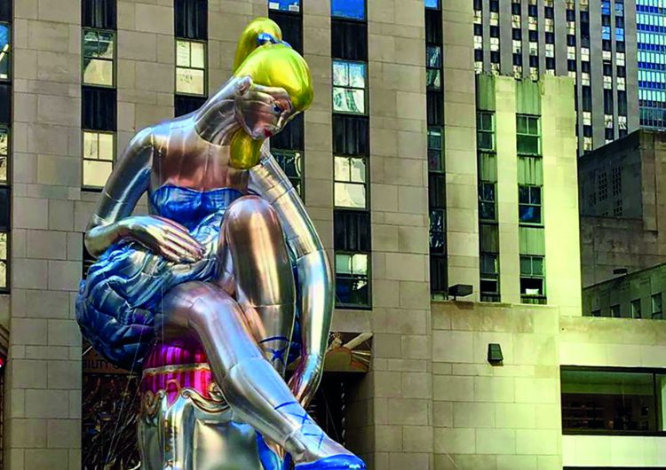 A seated ballerina in the middle of the Rockfeller Center