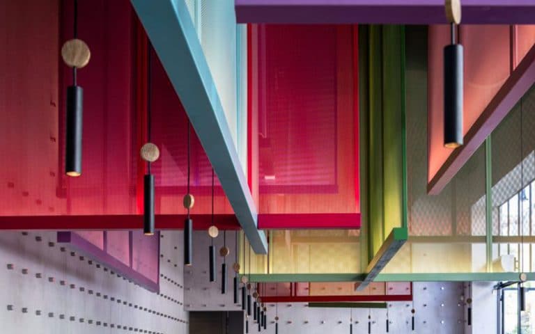 Colorful hanging screens play with the space in Telaviv