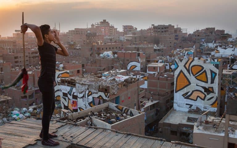 eL Seed paints a stunning massive mural in Cairo