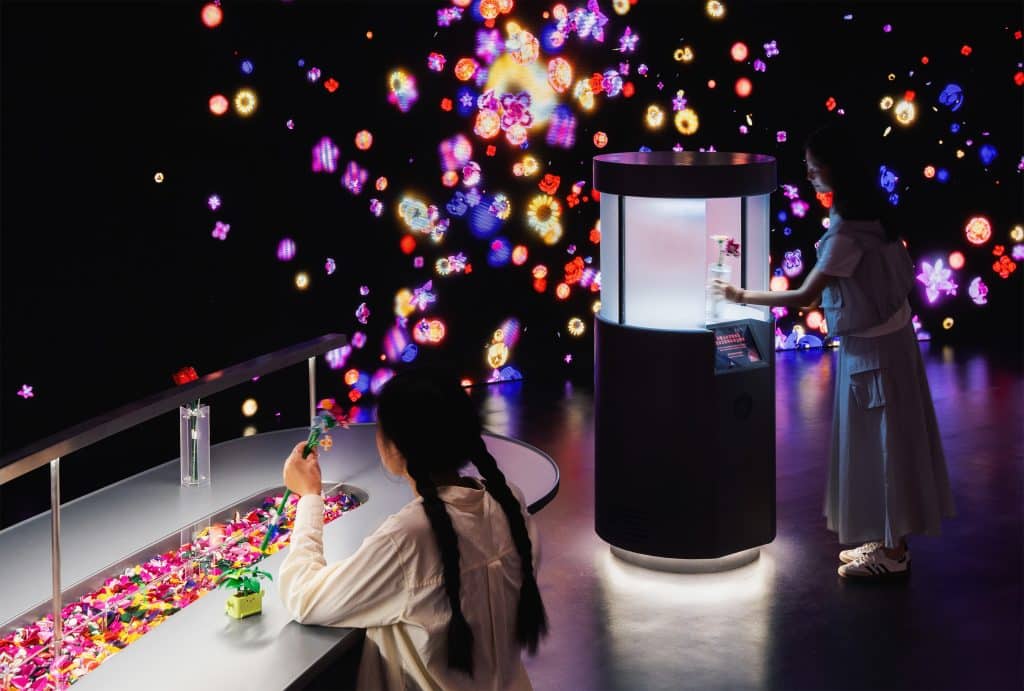 Visitors building LEGO flowers in the immersive digital room at TANK Shanghai