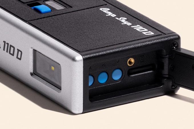 Open settings door of the Camp Snap 110D with blue buttons and microSD slot