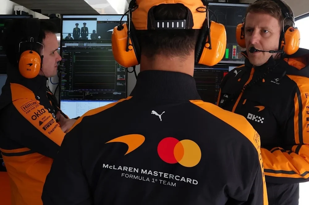 McLaren Racing team members wearing kit with the new identity