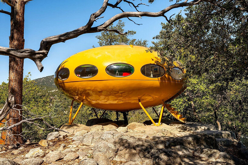 Side view of the yellow Futuro house on steel legs with oval windows