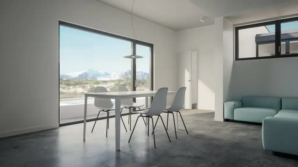 White living and dining room in Monocabin XL5 with grey floor, light blue sofa and a large window onto the desert