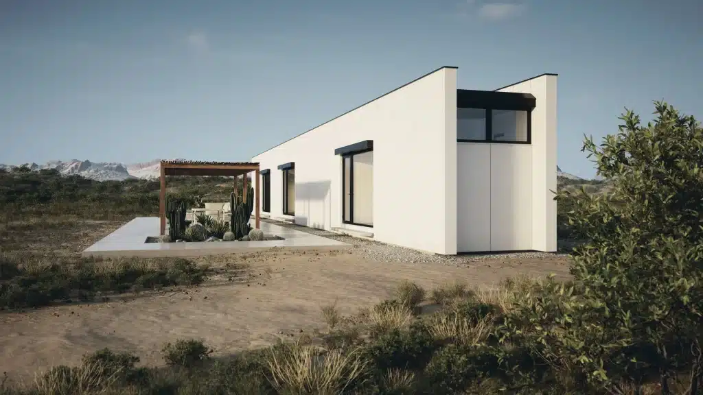 Corner of the white Monocabin XL5 house with a shaded patio and desert vegetation