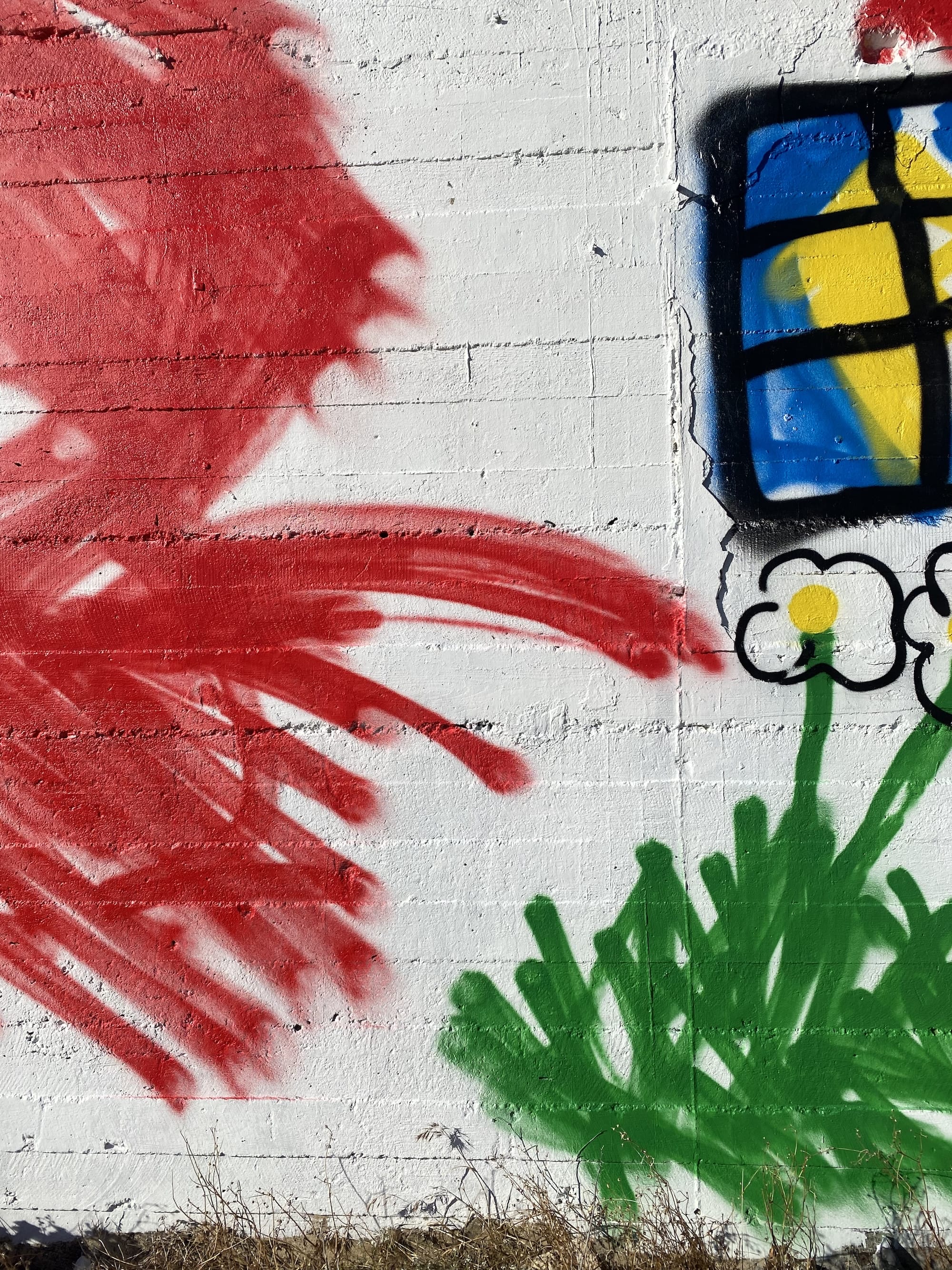 Detail of a World War II bunker painted by The Wa with childlike windows and scribbles