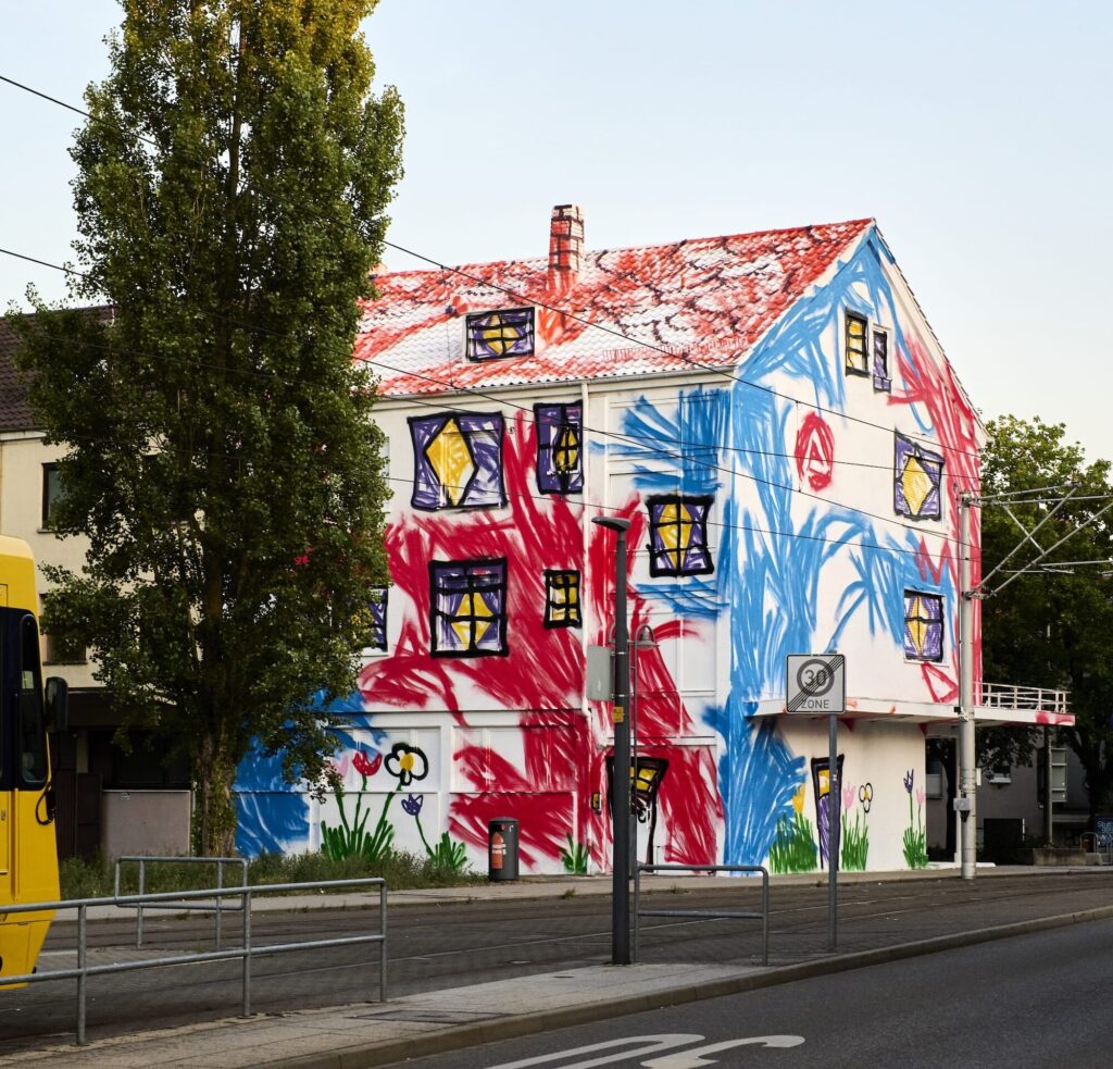 The Wa paints war bunkers and empty houses the way a child would