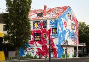 The Wa paints war bunkers and empty houses the way a child would