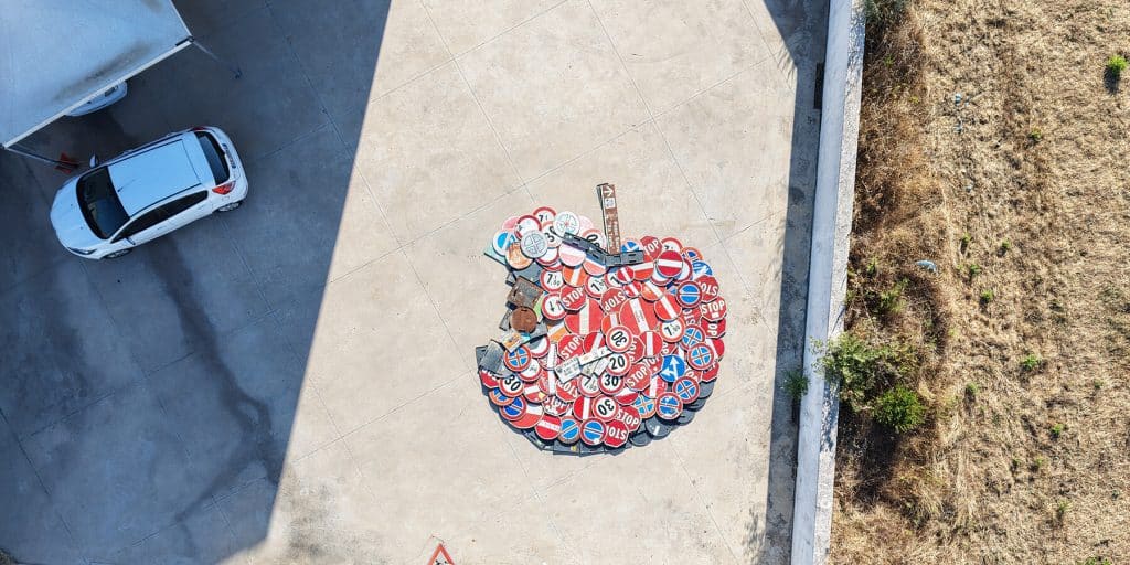 Recovered road signs forming Hokusai’s Great Wave on a beach in Sardinia