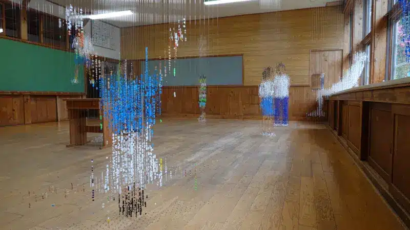 Wide view of the classroom with several bead figures of children